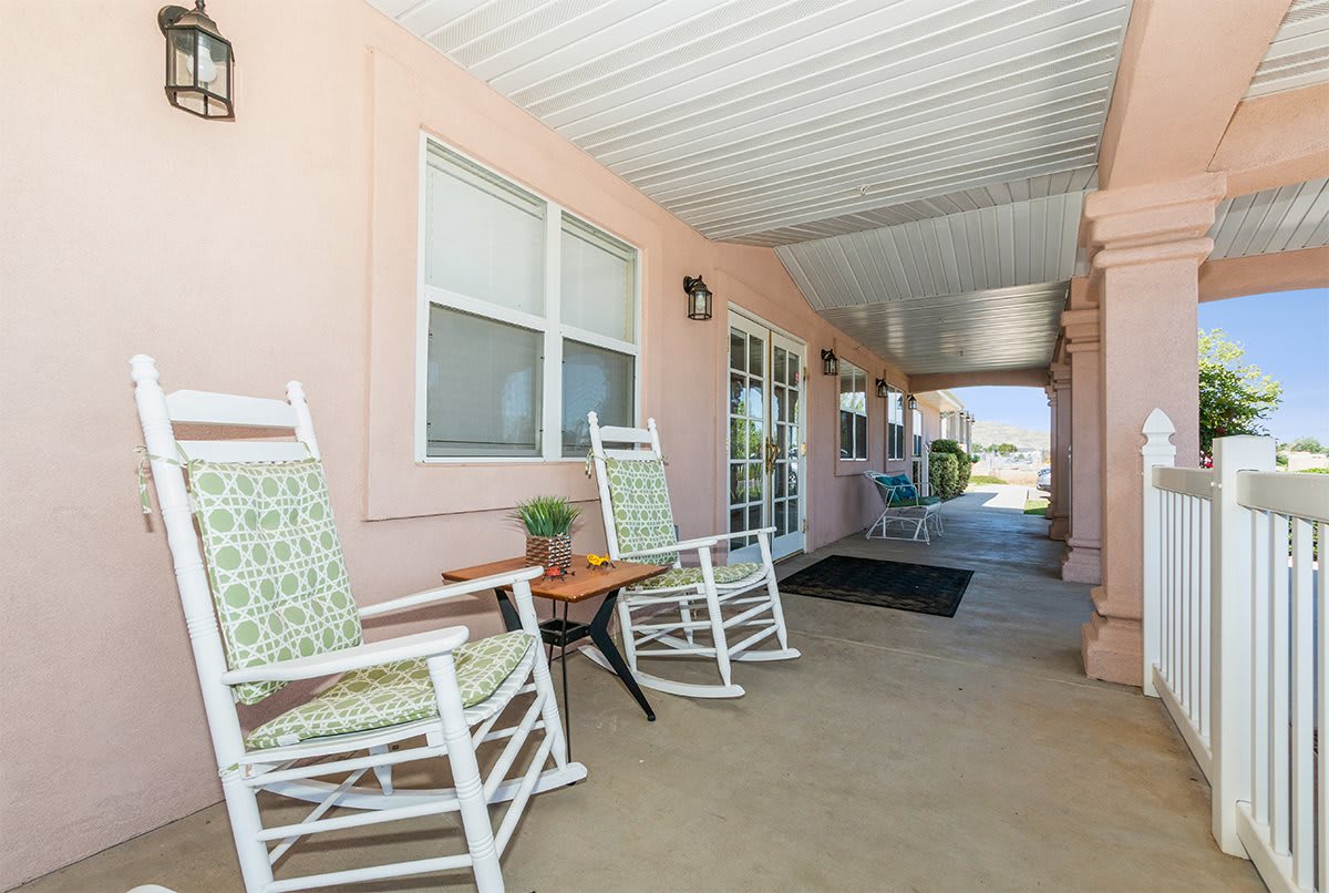 A cozy porch with rocking chairs and a covered walkway.