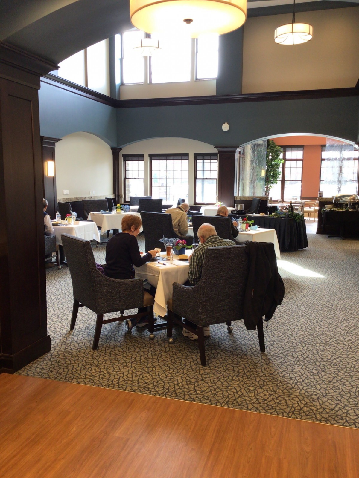 A cozy dining area with people enjoying a meal together.