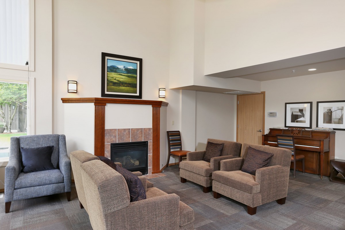 A modern living room with comfortable seating and a cozy fireplace.