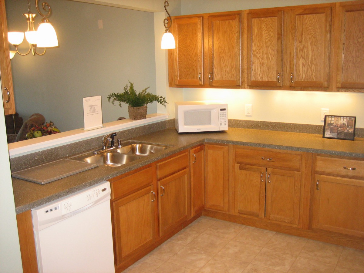A cozy kitchen with wooden cabinets and modern appliances.
