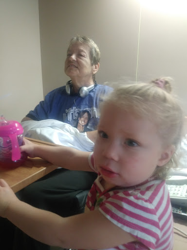 A tender moment shared between a child and an elderly adult in a hospital setting.