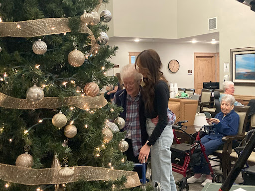 A heartwarming moment of family togetherness as they decorate the Christmas tree.
