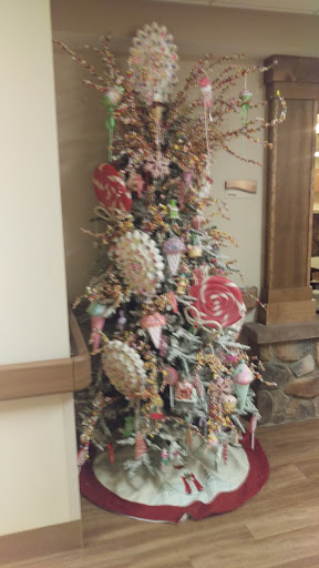A beautifully decorated Christmas tree adorned with an array of colorful ornaments and festive accents.
