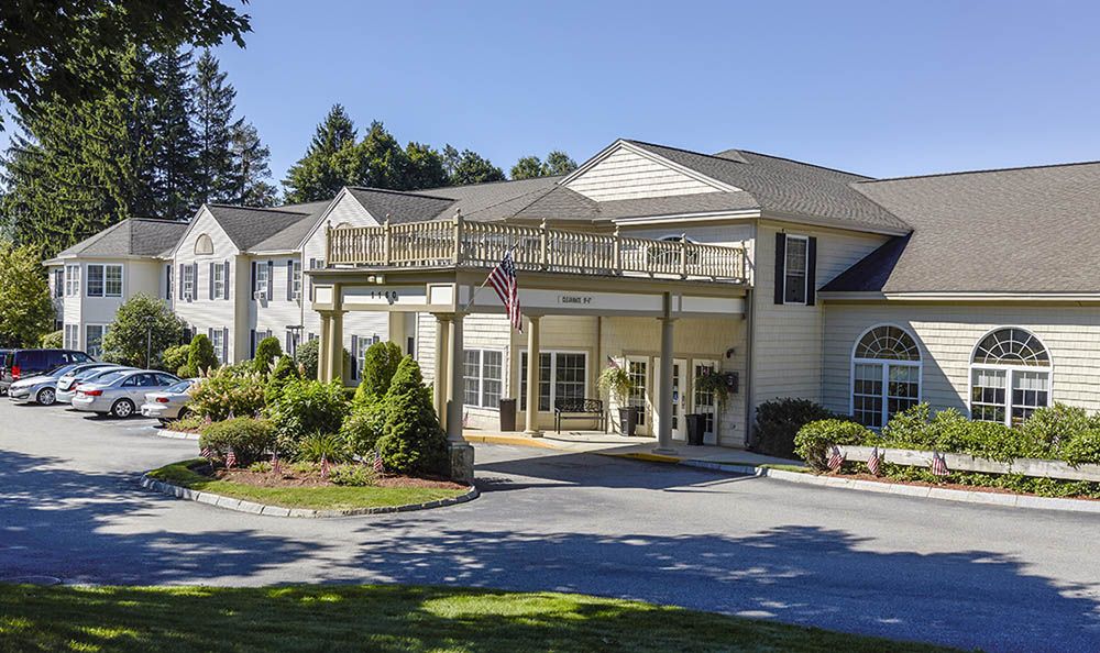 A well-maintained residential building with landscaped surroundings and clear blue skies.