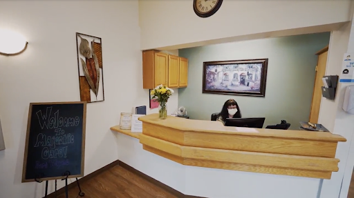A warm and welcoming reception area featuring a staff member at the desk.