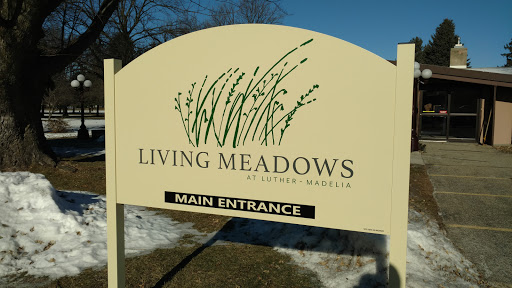 Main entrance sign for Living Meadows, highlighting a connection with nature.