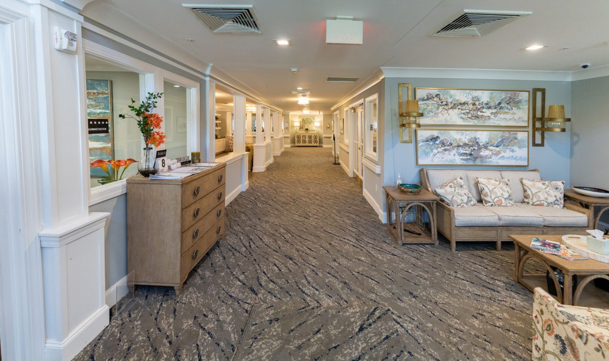 A well-decorated hallway with carpeted flooring and stylish furniture.