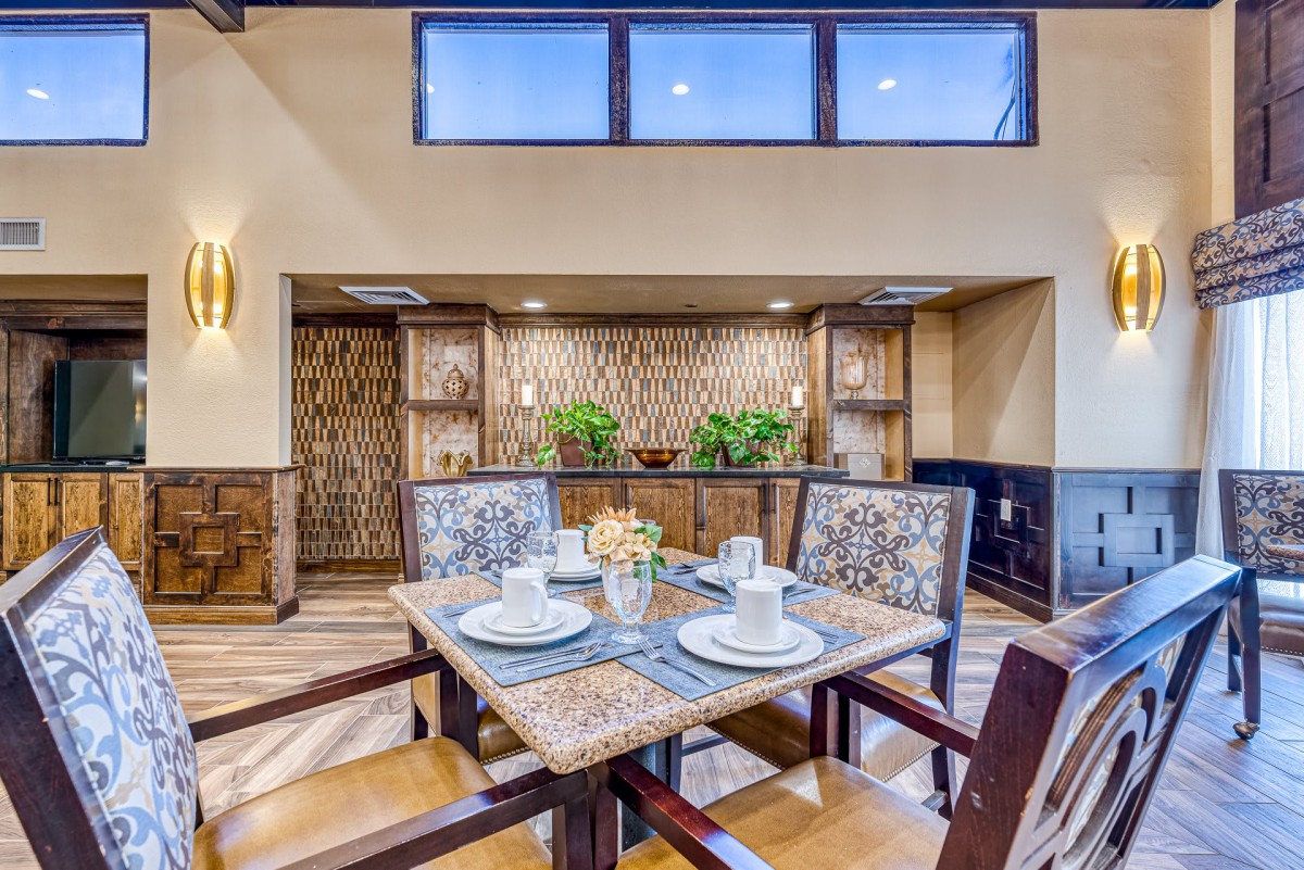 A cozy and contemporary dining room with a neatly set table and stylish decor.