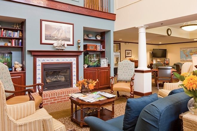 A cozy living room with a fireplace and comfortable seating.
