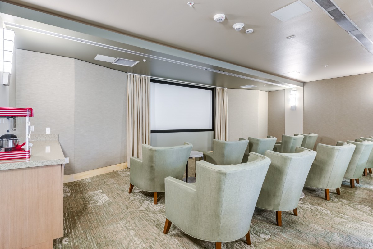 A cozy home theater with comfortable seating and a large screen.