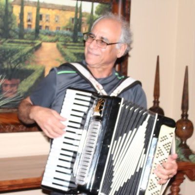 A musician playing the accordion indoors.