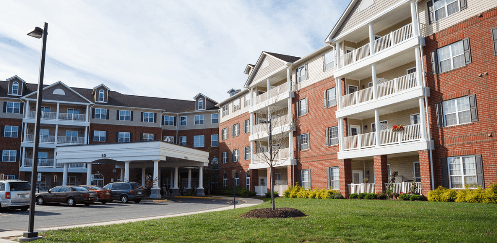A multi-story residential apartment building with a brick exterior and balconies.