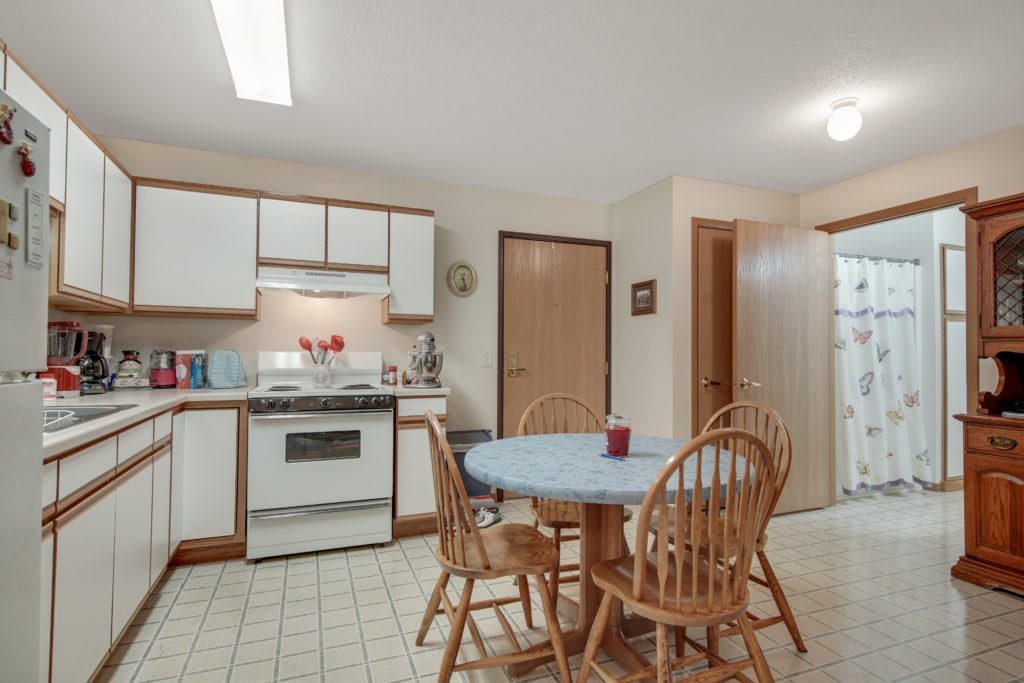 A cozy kitchen and dining area with a wooden table and chairs.