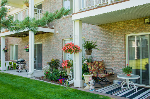 A cozy outdoor space with vibrant flowers and comfortable seating, perfect for relaxing.