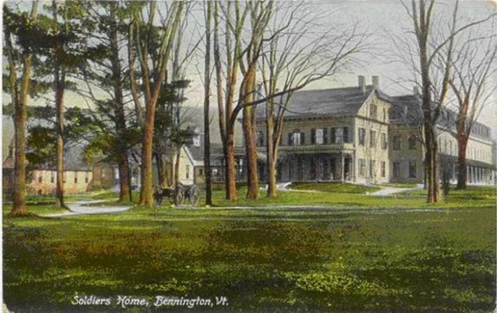 A vintage postcard depicting an historic house surrounded by trees.