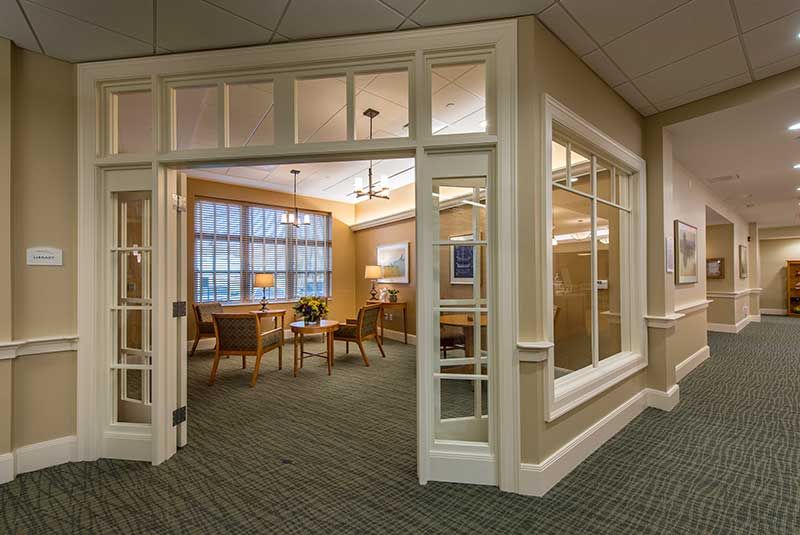 A cozy lobby area with seating and large windows.