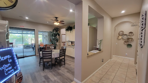 A spacious kitchen and dining area featuring modern furniture and decorative plants.
