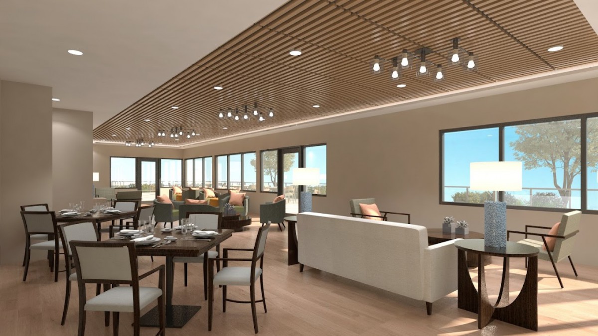 A modern and spacious living and dining area with contemporary furniture and wooden ceiling details.