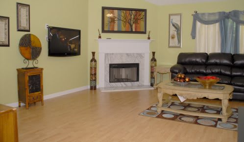 A cozy living room featuring a fireplace, television, and stylish decor.