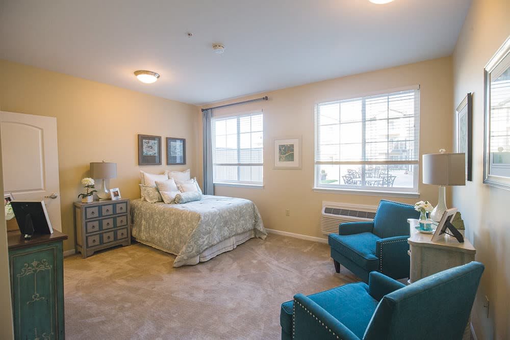 A cozy bedroom with elegant furnishings and natural light.