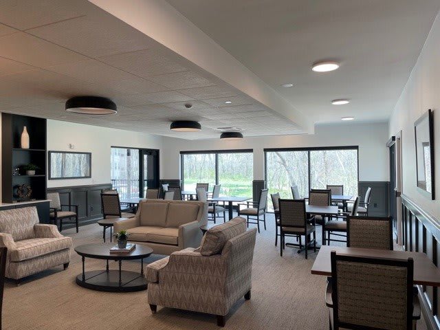 A spacious and modern lounge area with comfortable seating and large windows allowing for natural light.