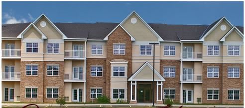 A multi-story residential apartment building with a brick facade.