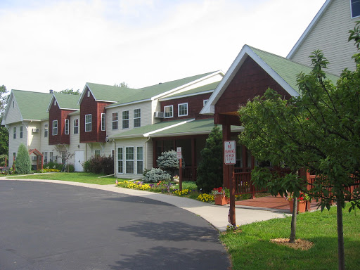 A beautiful residential building with a green roof and landscaped surroundings.