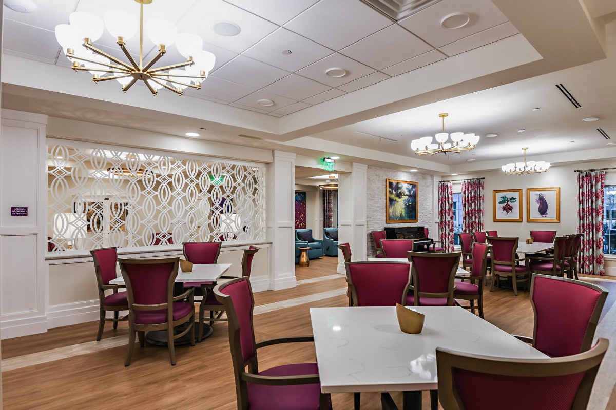 A modern dining area with elegantly arranged tables and chairs.