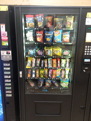A vending machine filled with a variety of snacks and drinks.