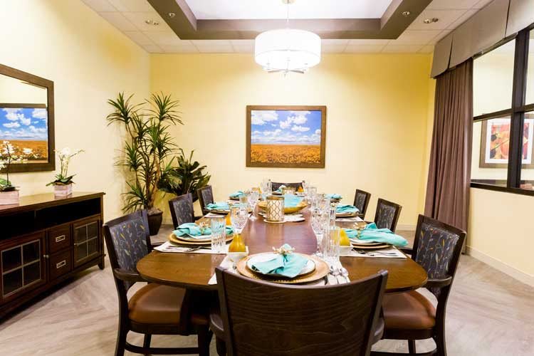 An elegantly set dining room table with place settings and decorative elements.