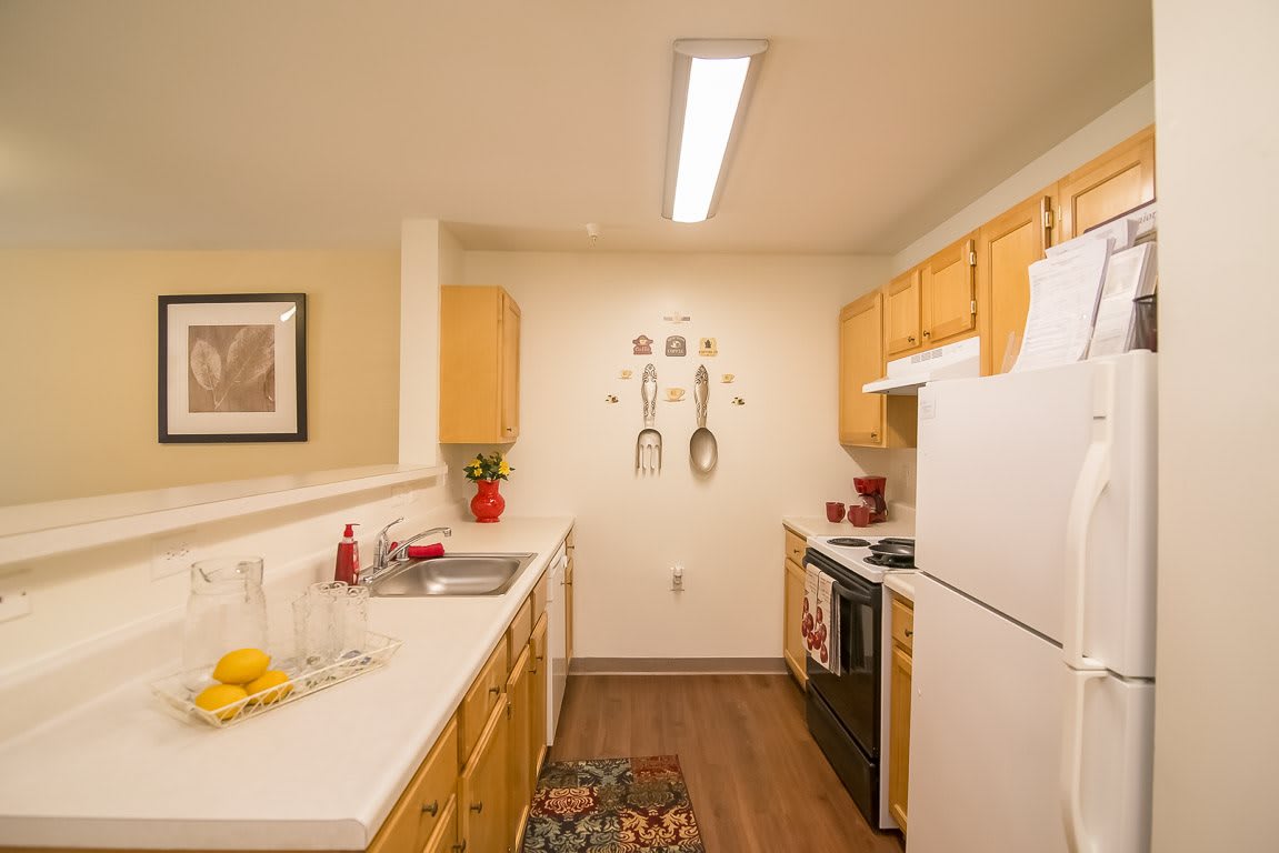 A cozy kitchen with wooden cabinets, modern appliances, and decorative touches.