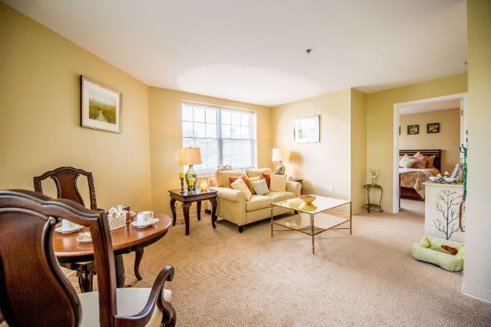 A cozy living room with a sofa, coffee table, and warm lighting.