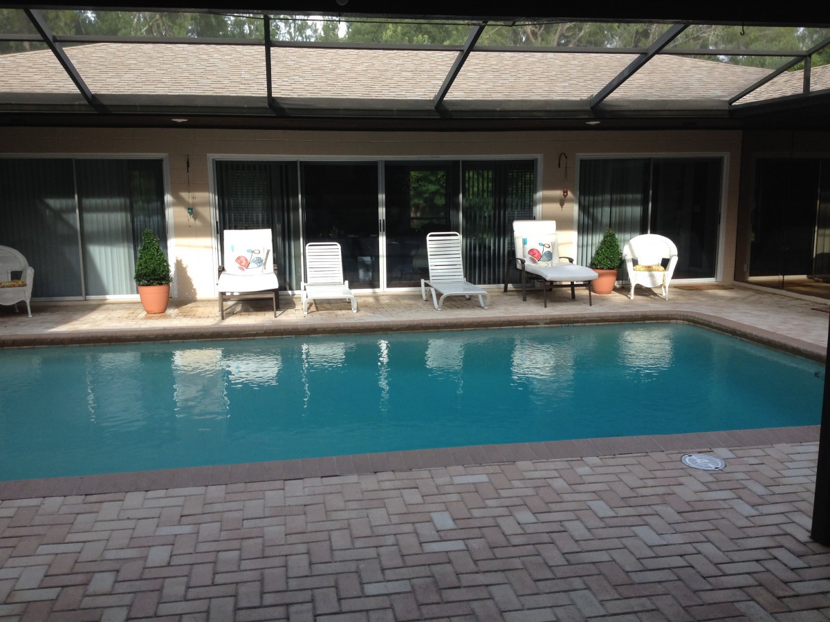 A serene backyard with a swimming pool and comfortable outdoor seating.
