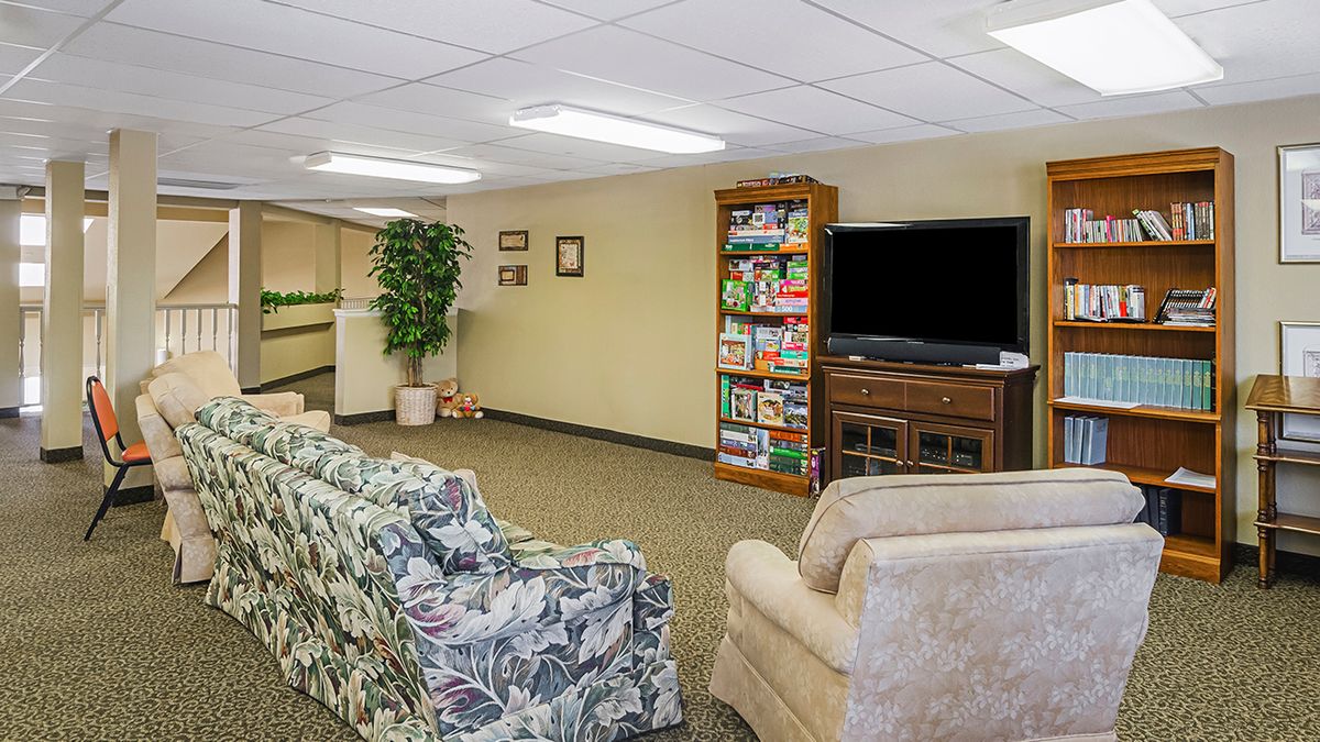 A cozy basement living room with comfortable seating and entertainment options.