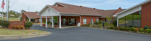 A welcoming residential building with a covered entrance and landscaped surroundings.