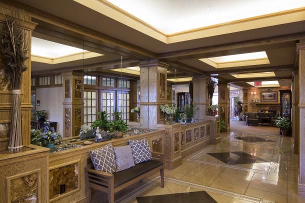 A stylish lobby with modern architectural features, including a seating area and ceiling lights.