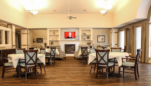 A cozy dining area with comfortable seating, a fireplace, and a television for communal enjoyment.