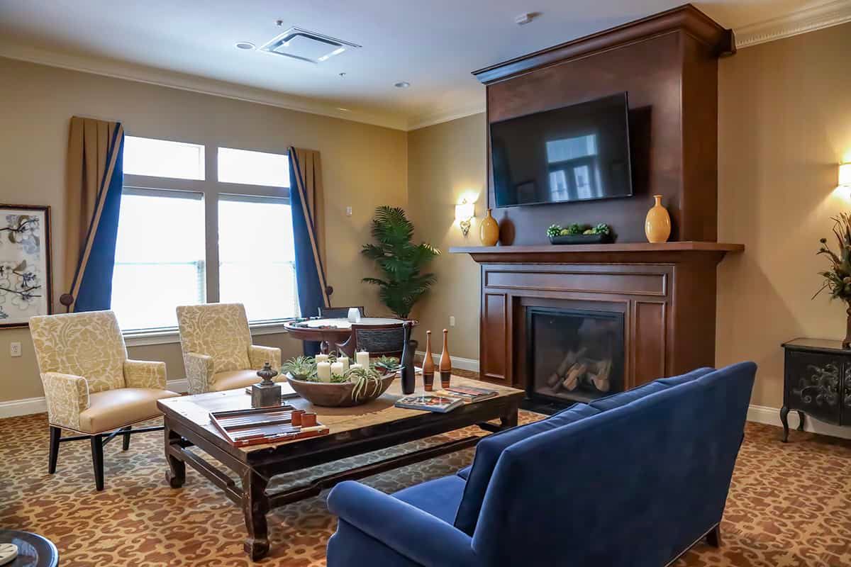 A cozy living room with a fireplace, television, and comfortable seating.