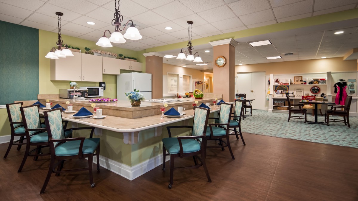 A modern kitchen and dining area with stylish lighting and seating.