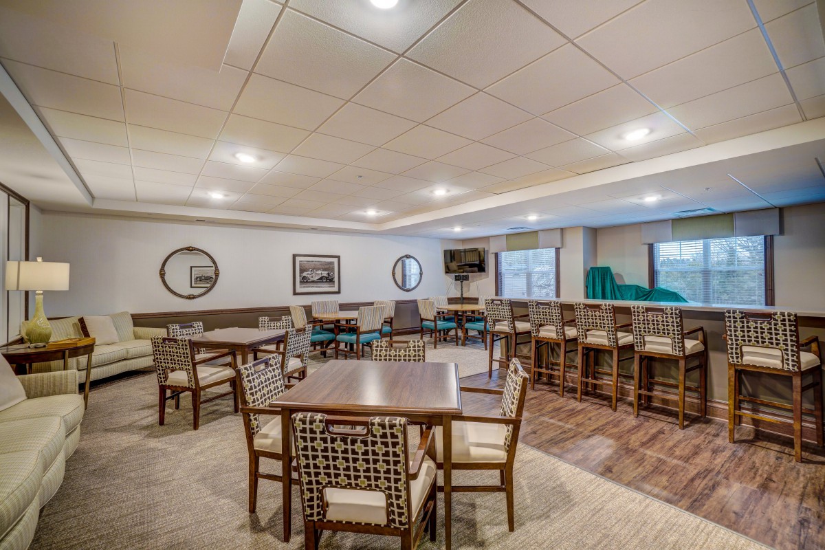 A spacious conference room with multiple tables and chairs arranged for meetings.