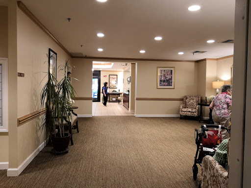 A spacious lobby area featuring comfortable seating, decorative plants, and warm lighting.