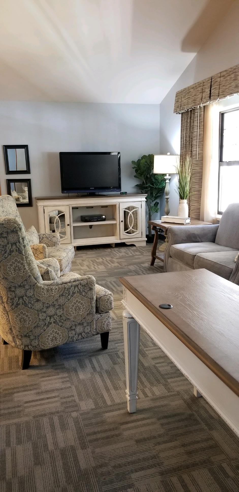 A cozy living room with comfortable seating and a television.