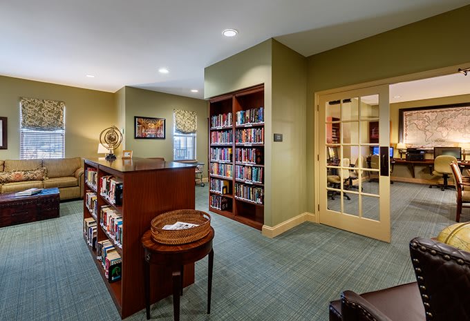 A cozy library interior with bookshelves and a comfortable reading area.