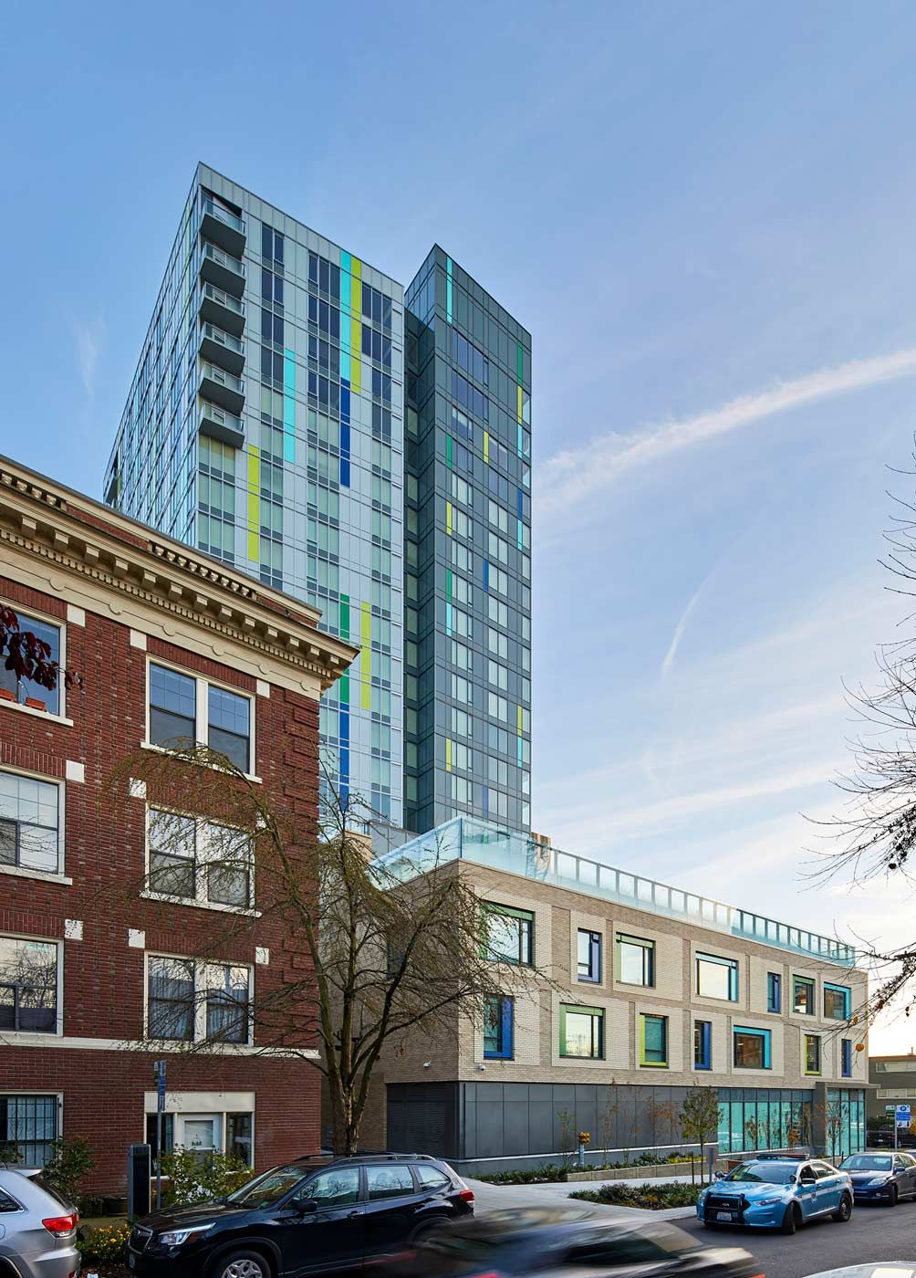 A modern skyscraper towers over older urban architecture.
