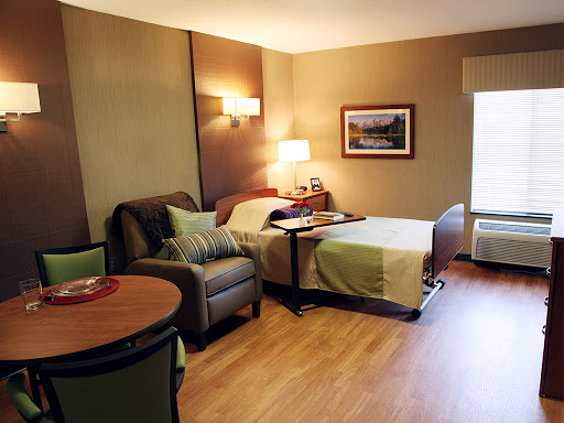 A cozy hotel room featuring modern furniture and warm lighting.