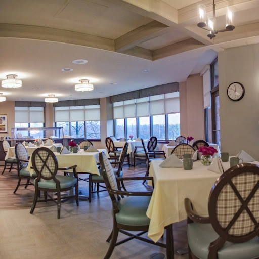 A well-lit dining area featuring elegantly set tables and a cozy ambiance.