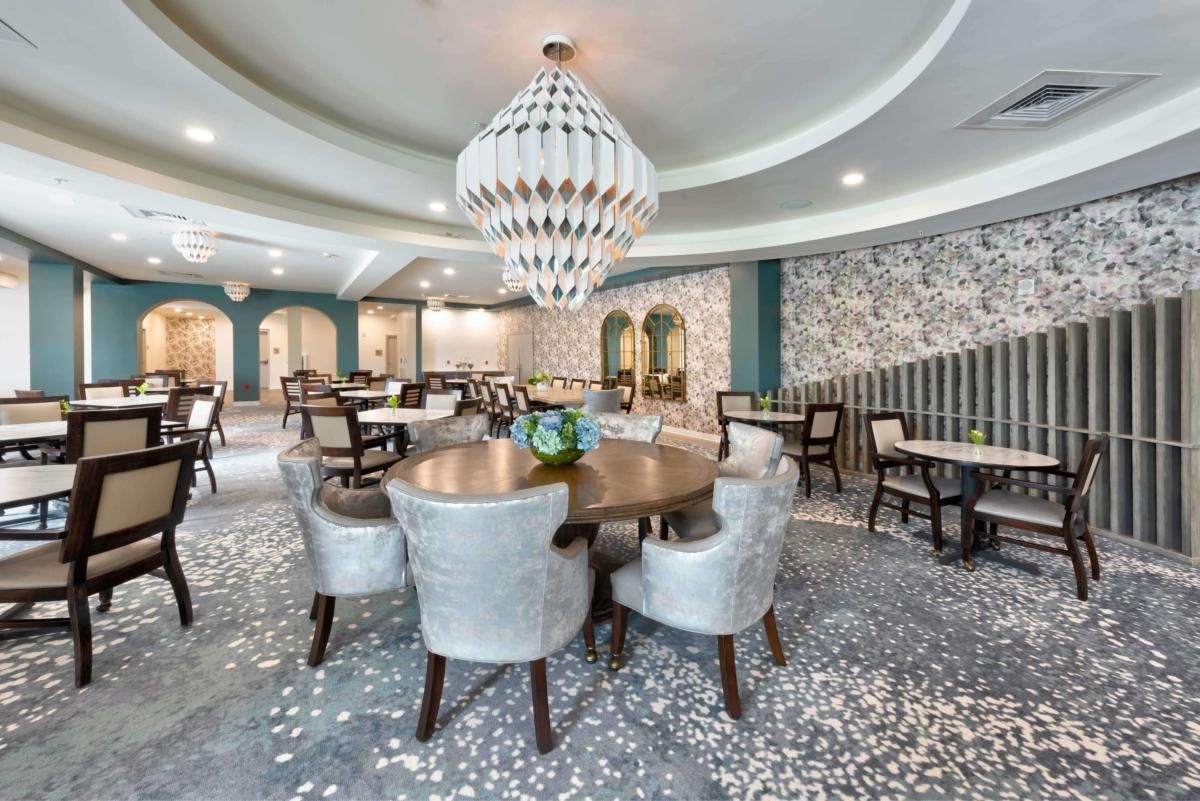 Elegant dining area with modern decor and a striking chandelier.