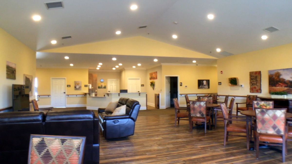 A spacious living area with comfortable seating and warm lighting.