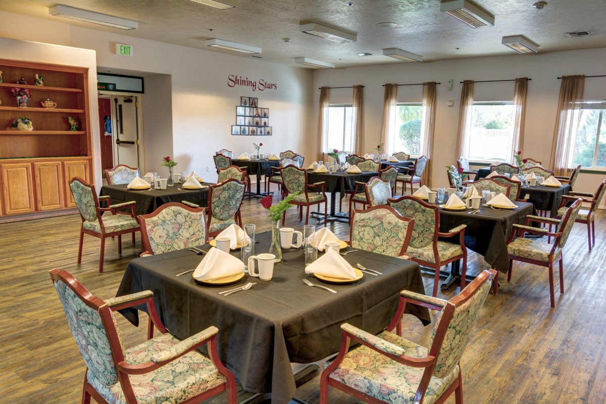 An elegantly set dining area with neatly arranged tables and chairs.