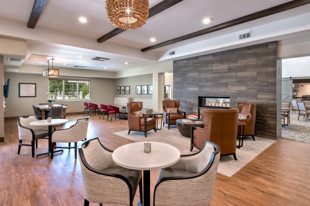 A modern and cozy lounge area with elegant seating arrangements and a fireplace.